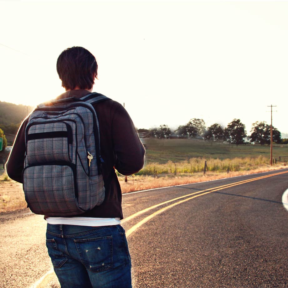Stock photo of a person looking at a long road 